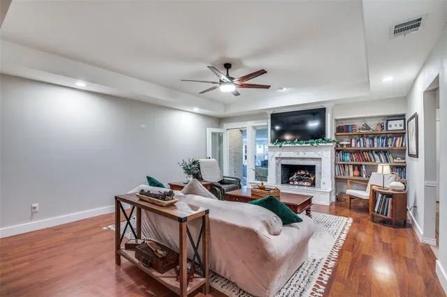 a living room with furniture a fireplace and a flat screen tv