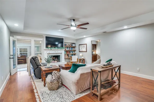 a living room with furniture a fireplace and a flat screen tv