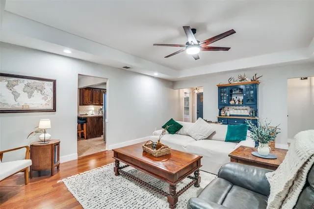 a living room with furniture and wooden floor