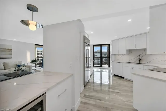 a kitchen with a sink stainless steel appliances and cabinets