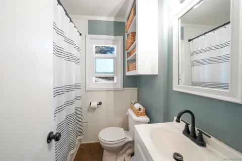 a bathroom with a sink toilet and a mirror