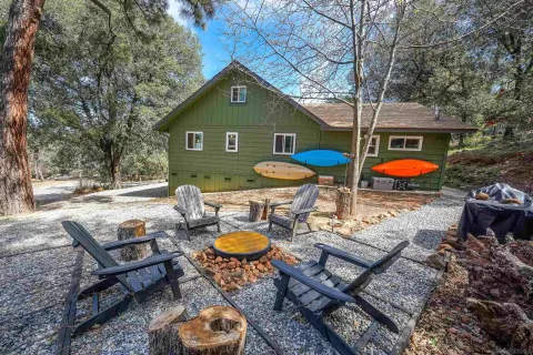 a view of a chairs and table in backyard
