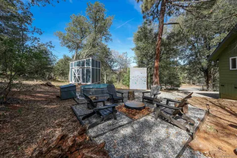 a view of a backyard with chairs and table