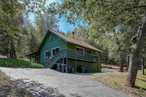 a view of a house with a yard and garage