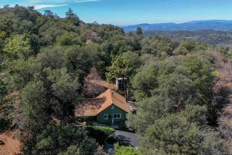 an aerial view of a house with yard and outdoor seating