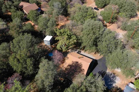 an aerial view of a house with a yard