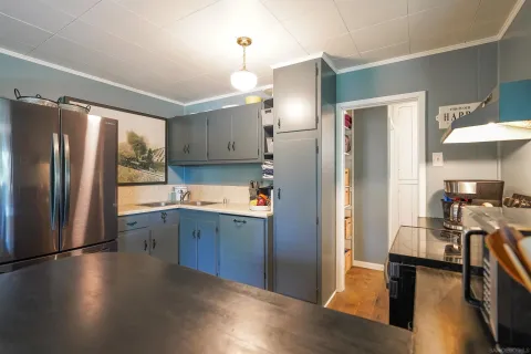 a kitchen with stainless steel appliances granite countertop a refrigerator and a sink