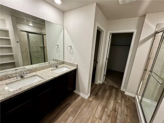 a bathroom with a sink a mirror and a shower