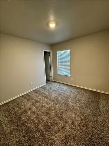 an empty room with a empty space and windows