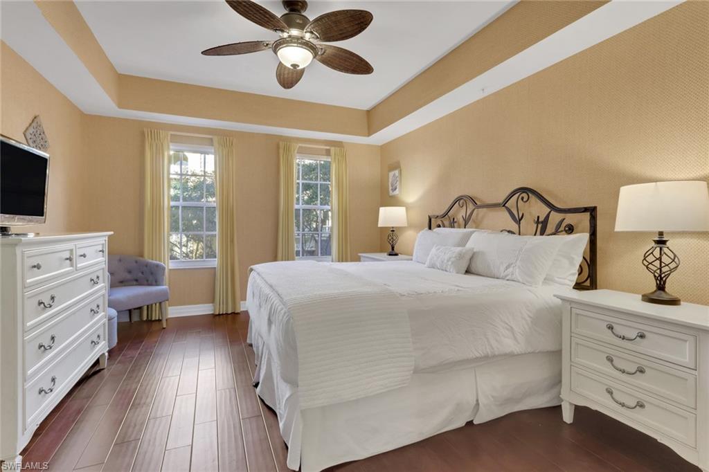 401 Bayfront Place, Unit 3207 Naples, FL 34102 - Photo 4 of 22 Bedroom featuring a tray ceiling, dark wood-style flooring, and ceiling fan