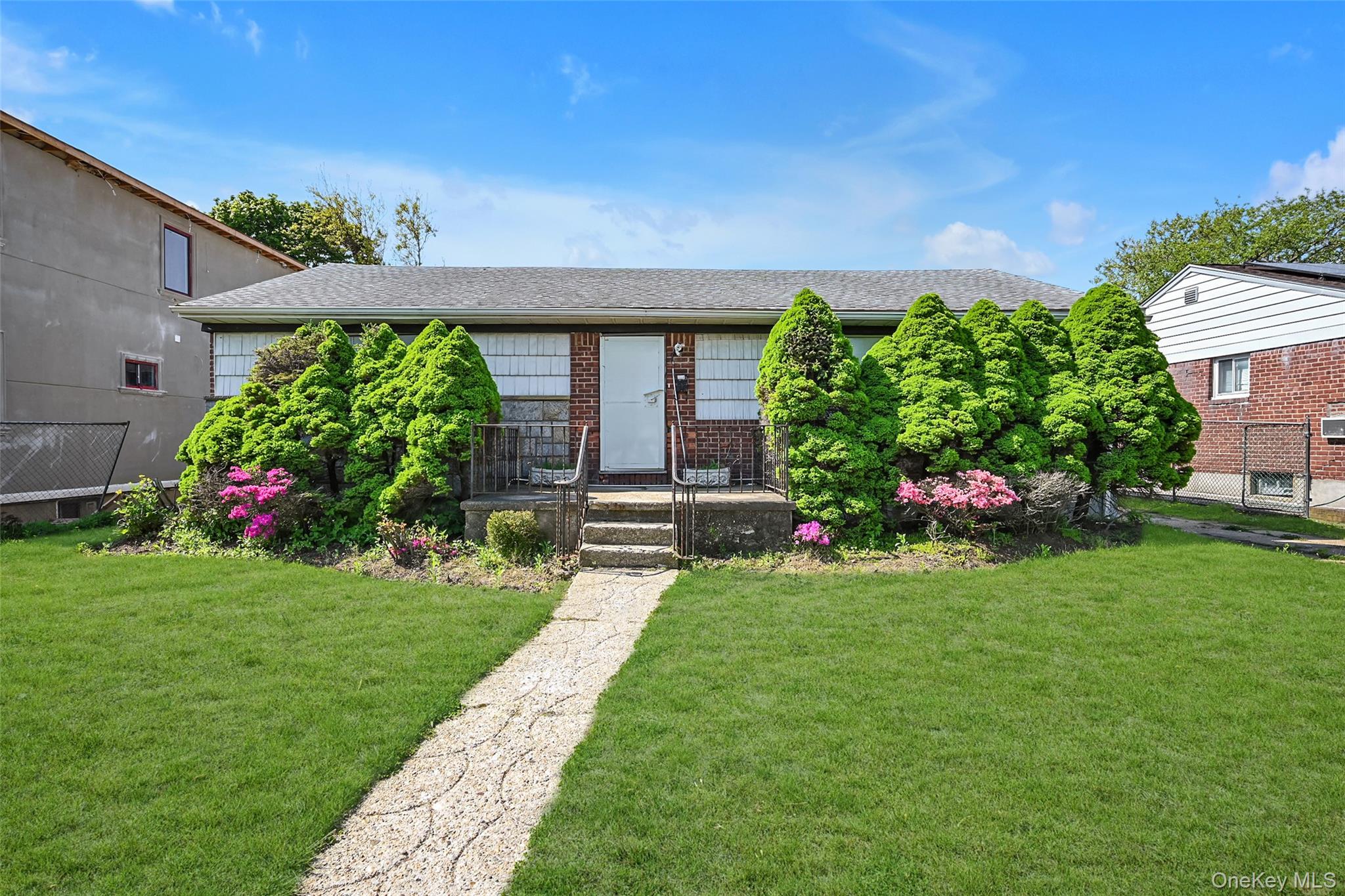 2255 Parkhurst Road Elmont, NY 11003 - Photo 1 of 24 a front view of a house with a yard