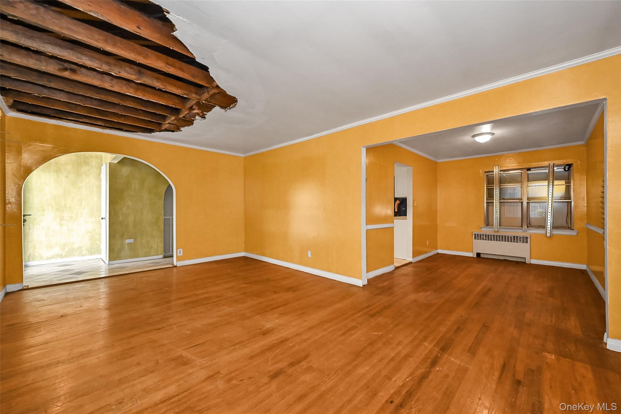 2255 Parkhurst Road Elmont, NY 11003 - Photo 3 of 24 a view of an empty room with wooden floor and a window