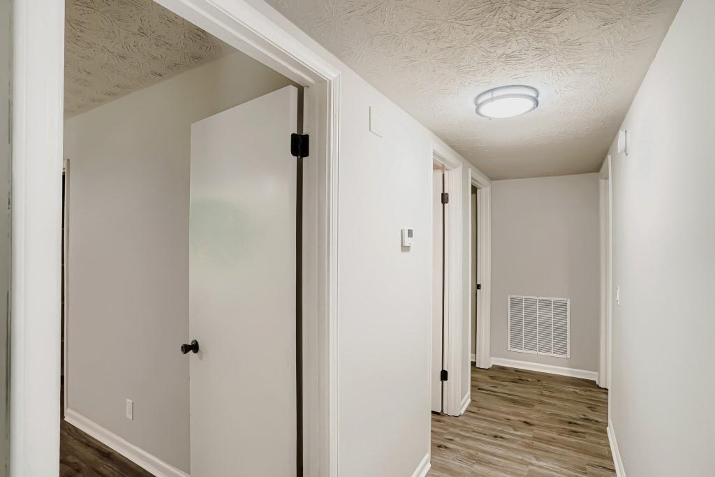 2021 Irwin Bridge Road Northwest Conyers, GA 30012 - Photo 8 of 43 a view of a hallway with wooden floor