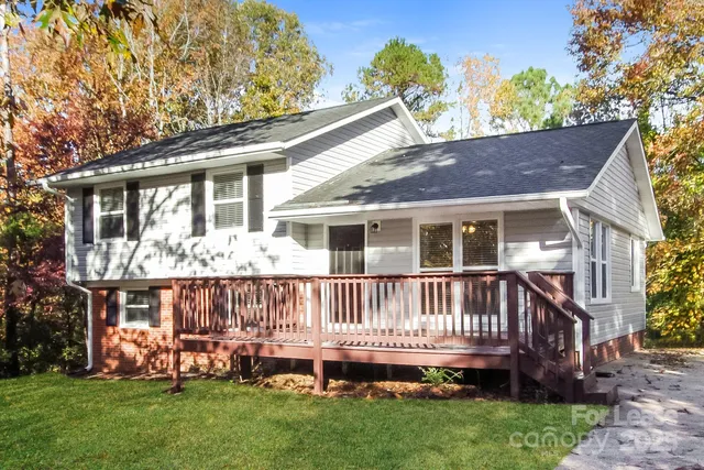 a front view of a house with a garden and deck