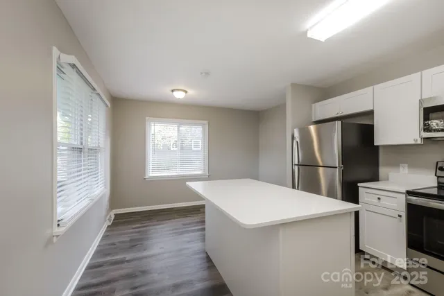a kitchen with a refrigerator a stove top oven a sink and dishwasher