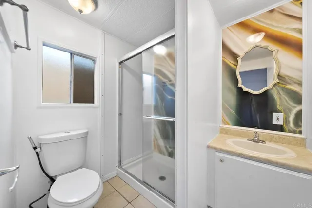 a bathroom with a toilet a sink and shower