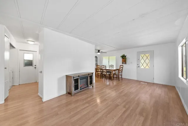 an empty room with wooden floor and fireplace