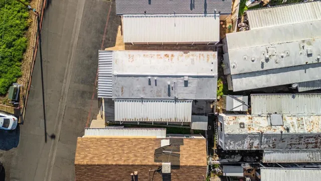 a view of kitchen with granite countertop lots of clutter and stainless steel appliances