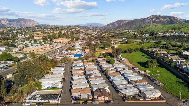 an aerial view of residential houses with city view