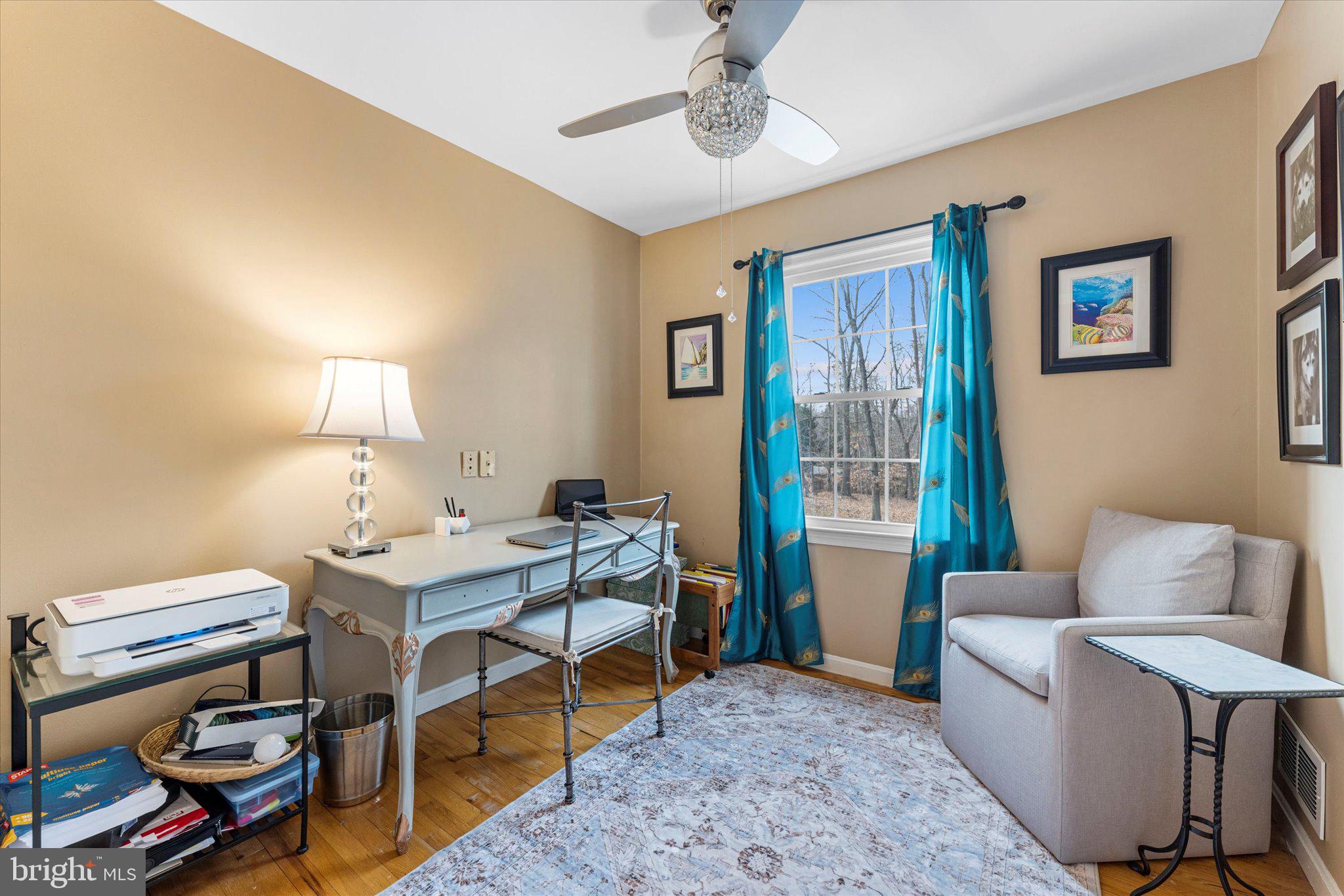 8015 Stillbrooke Road Manassas, VA 20112 - Photo 21 of 34 a living room with furniture a lamp and a window