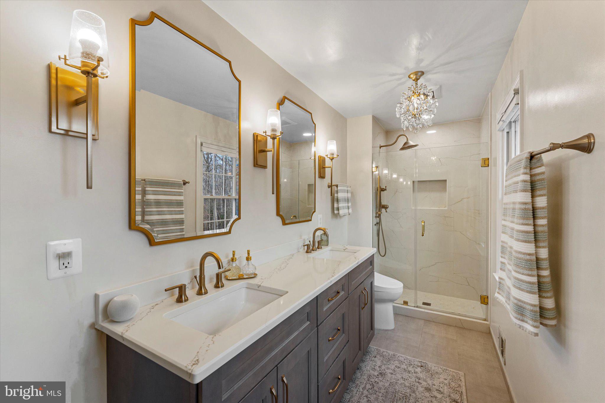 8015 Stillbrooke Road Manassas, VA 20112 - Photo 3 of 34 a bathroom with a sink vanity tub and a mirror