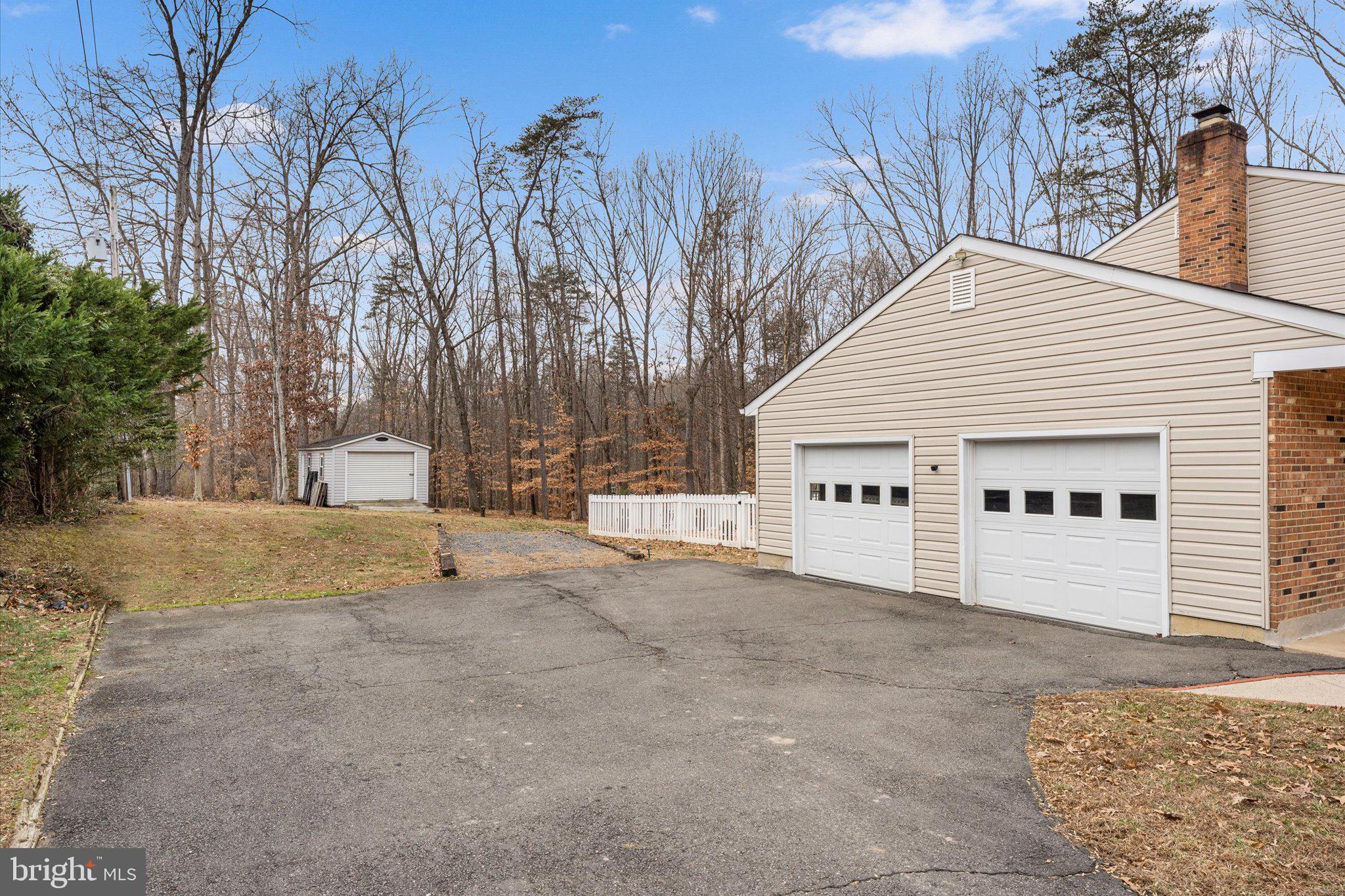 8015 Stillbrooke Road Manassas, VA 20112 - Photo 8 of 34 a view of a white house with a snow on the road