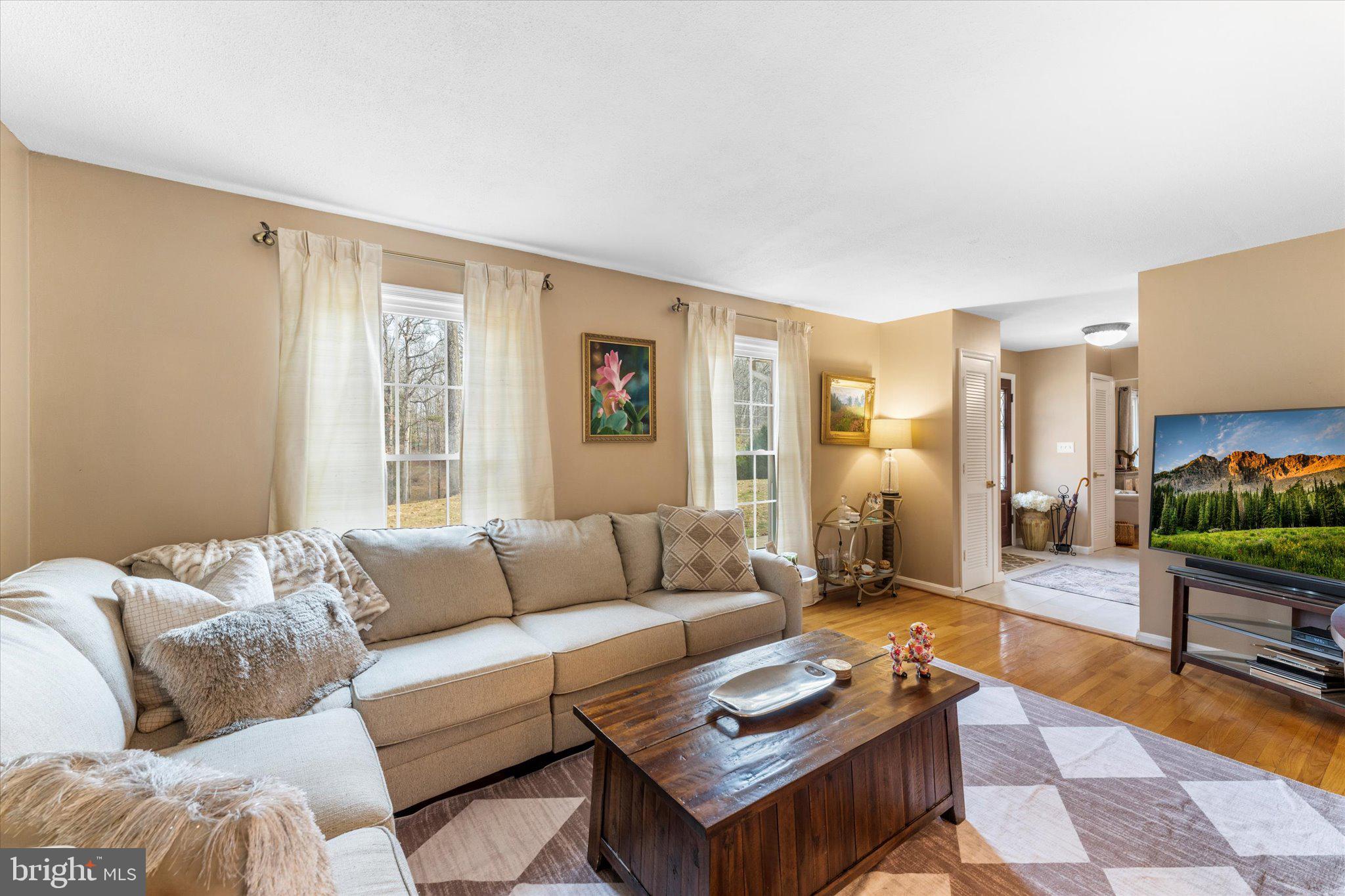 8015 Stillbrooke Road Manassas, VA 20112 - Photo 10 of 34 a living room with furniture a rug and a window
