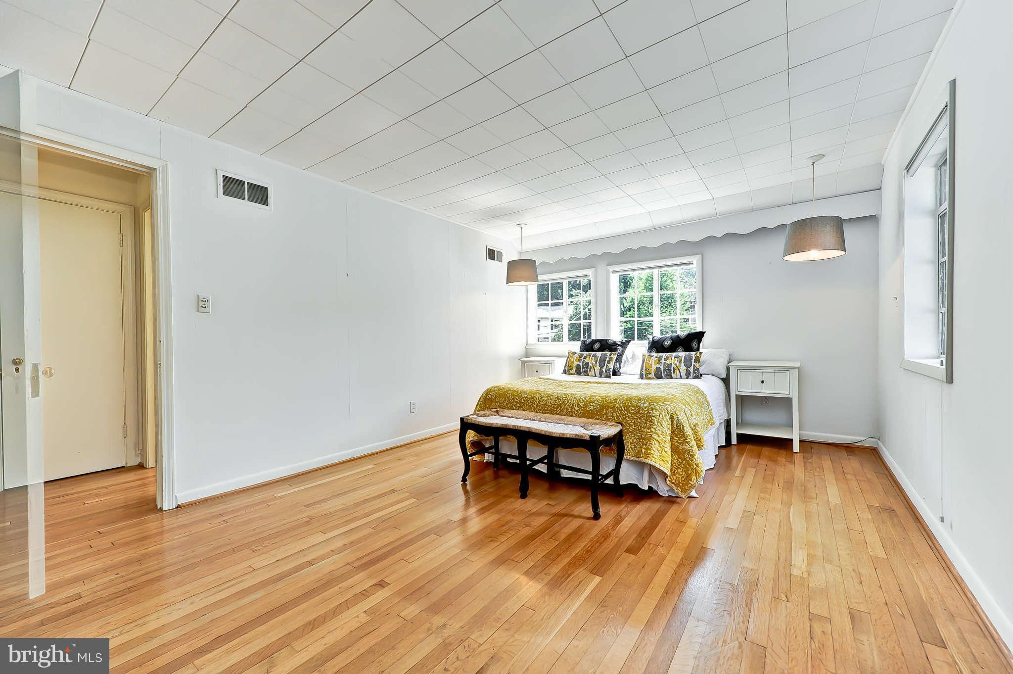 3203 Russell Road Alexandria, VA 22305 - Photo 19 of 30 a spacious bedroom with a bed and wooden floor