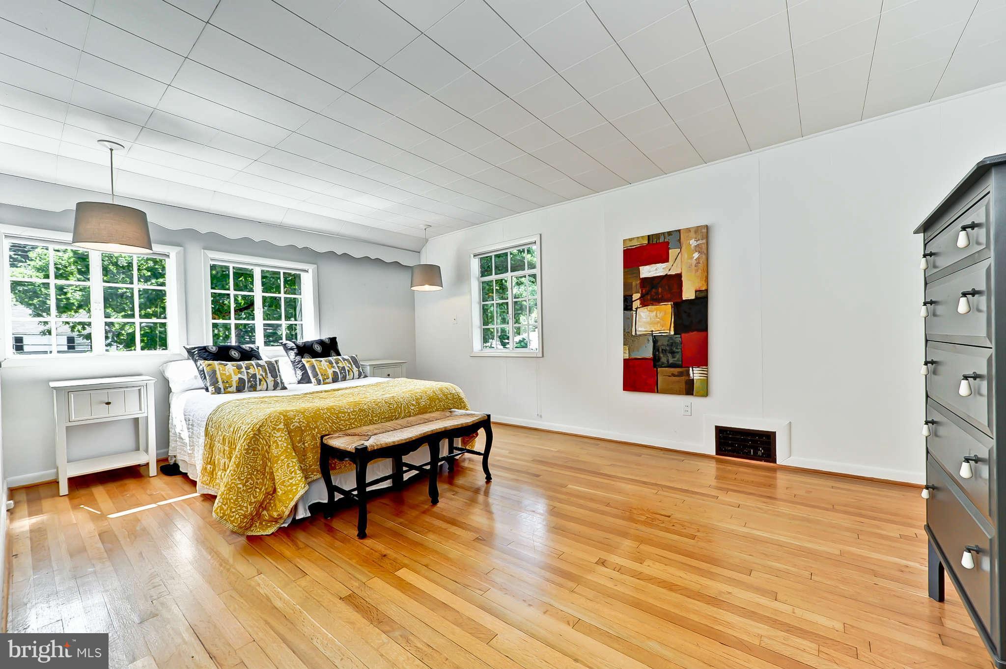 3203 Russell Road Alexandria, VA 22305 - Photo 20 of 30 a bedroom with a bed and wooden floor
