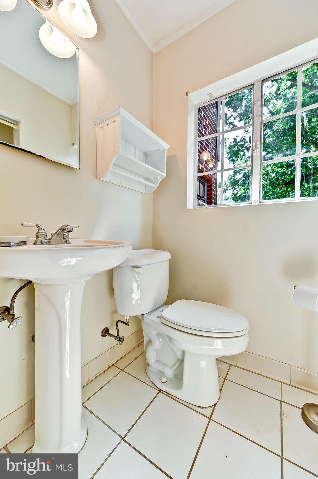 3203 Russell Road Alexandria, VA 22305 - Photo 21 of 30 a bathroom with a sink a toilet and a mirror