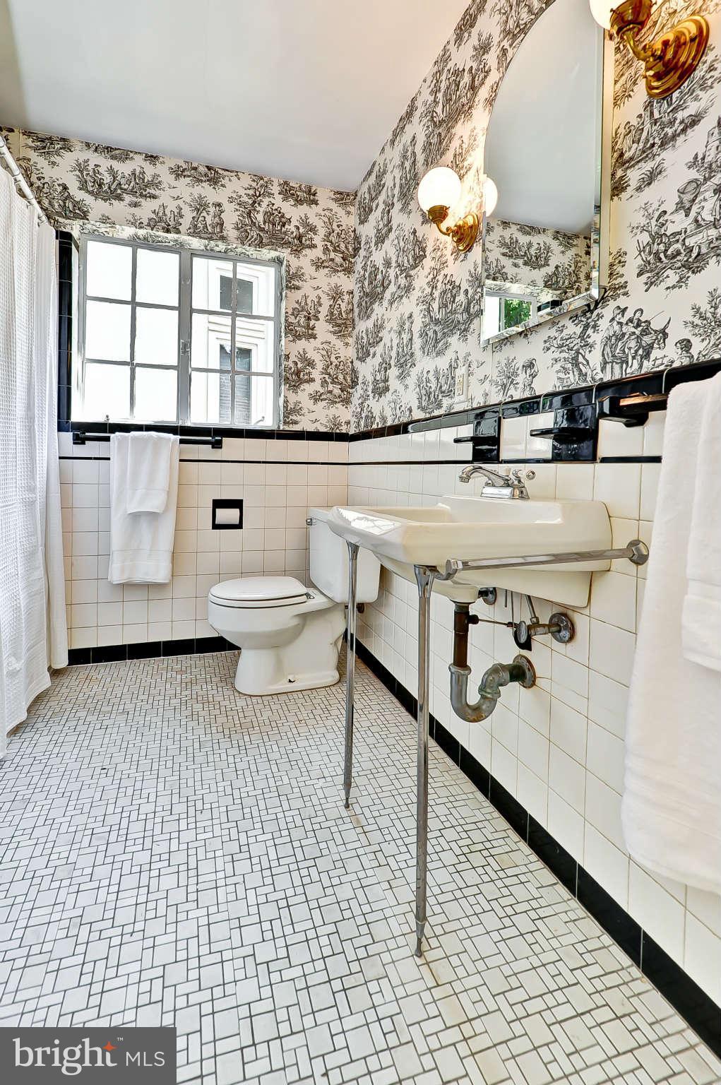 3203 Russell Road Alexandria, VA 22305 - Photo 24 of 30 a bathroom with a sink a toilet and mirror
