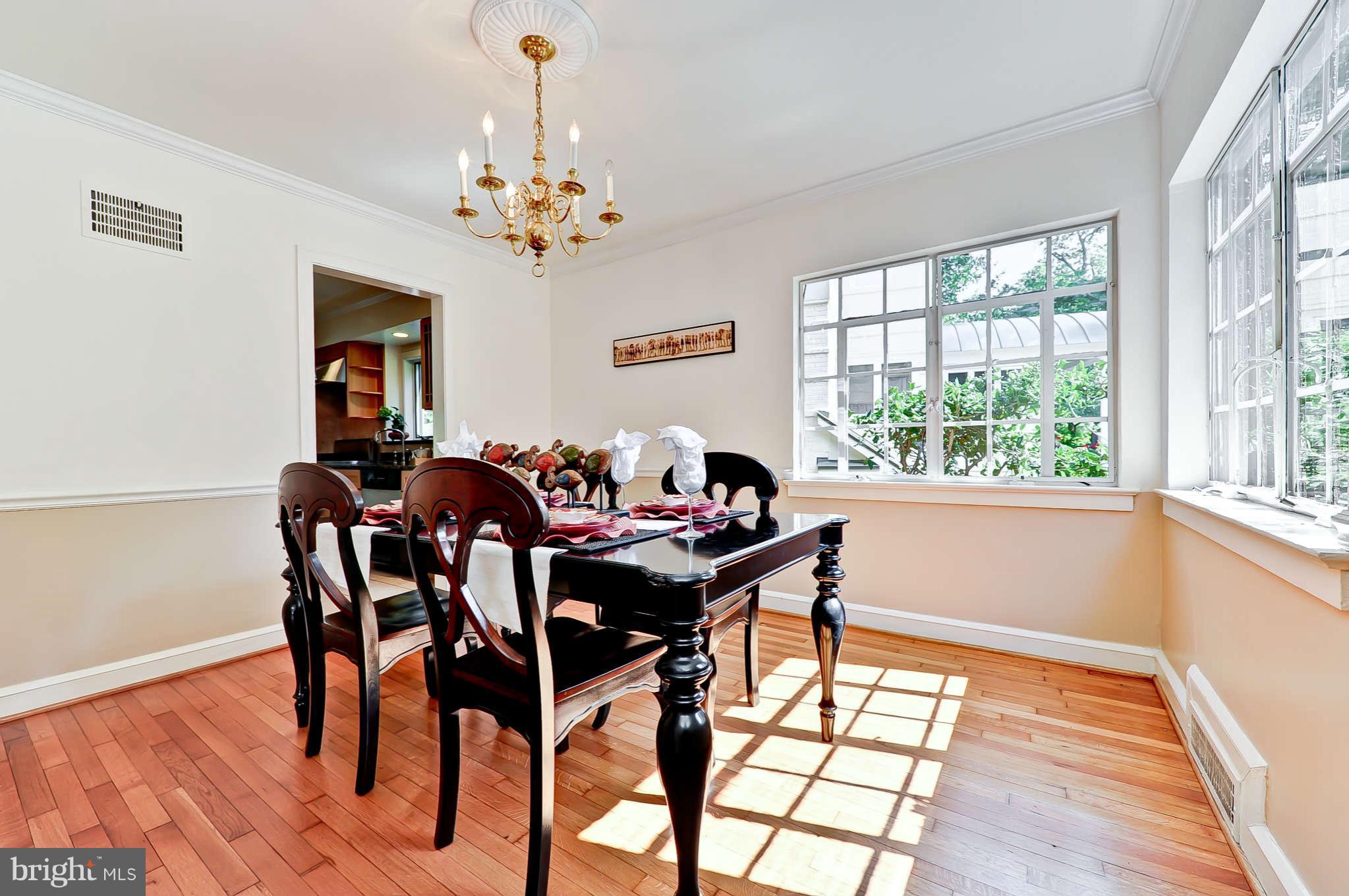 3203 Russell Road Alexandria, VA 22305 - Photo 9 of 30 a view of a dining room with furniture a chandelier and wooden floor