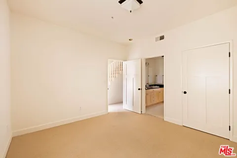 a view of a kitchen with a sink and a refrigerator