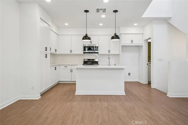 a view of kitchen with wooden floor and window
