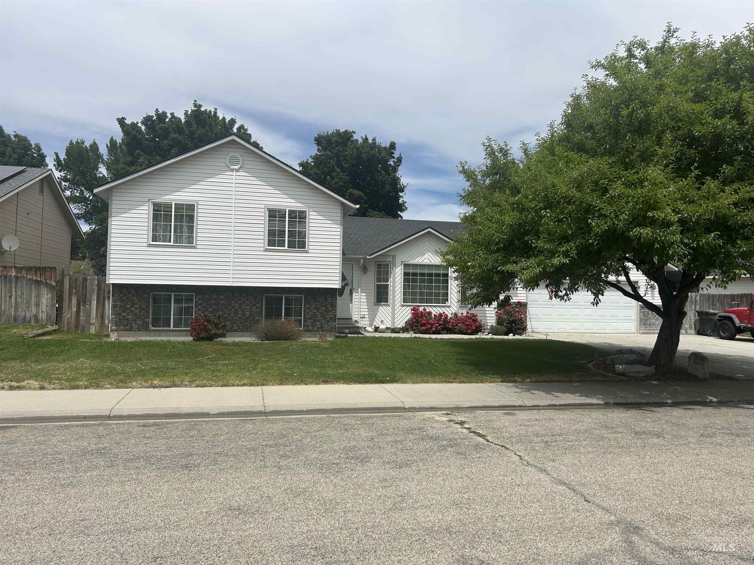 1444 East Doberman Street Meridian, ID 83642 - Photo 2 of 31 Split-level residence featuring white siding and a stone facade