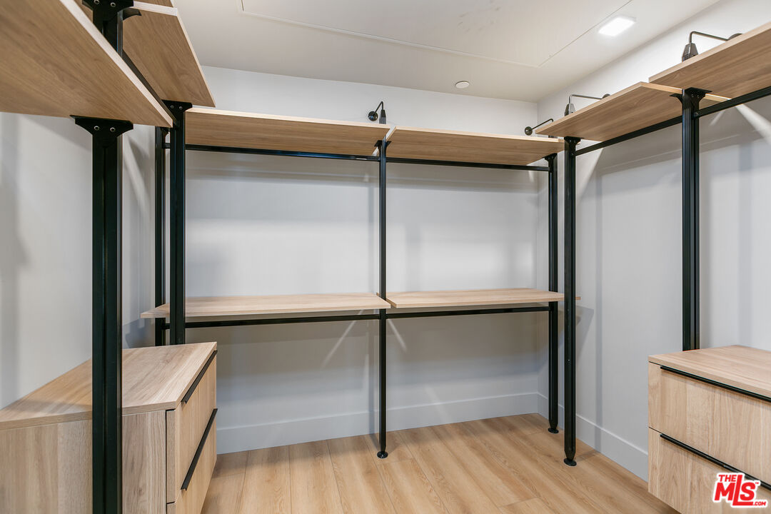 12431 Rochester Avenue, Unit 311 Los Angeles, CA 90025 - Photo 13 of 30 a room with wooden floor and windows