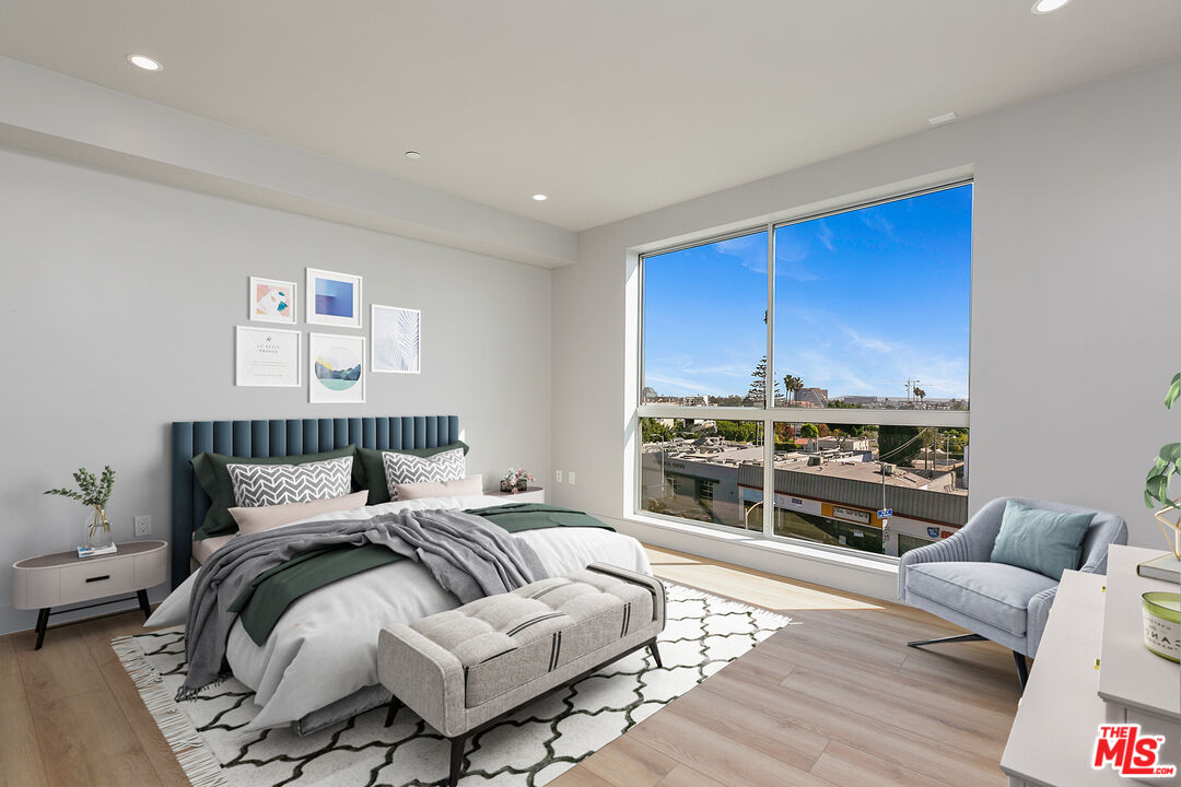 12431 Rochester Avenue, Unit 311 Los Angeles, CA 90025 - Photo 15 of 30 a bedroom with furniture and a floor to ceiling window
