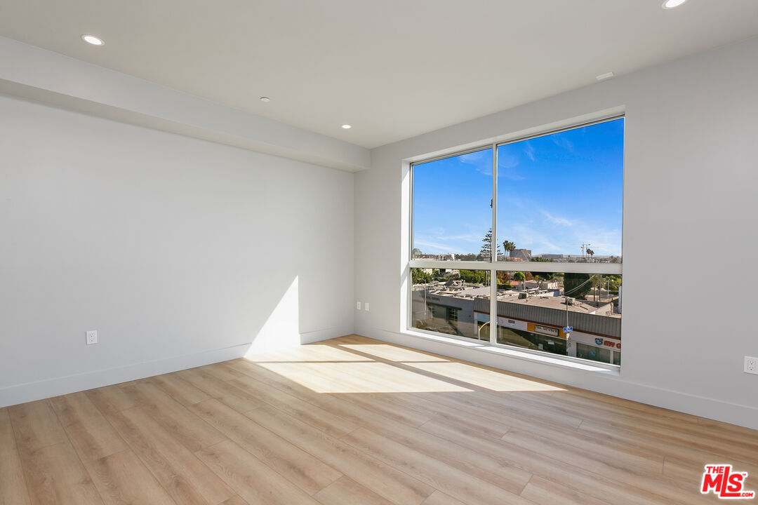 12431 Rochester Avenue, Unit 311 Los Angeles, CA 90025 - Photo 16 of 30 a view of a kitchen with wooden floor and iron cabinets