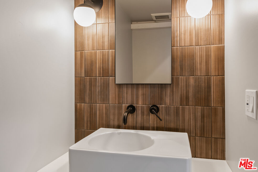 12431 Rochester Avenue, Unit 311 Los Angeles, CA 90025 - Photo 6 of 30 a bathroom with a sink and a shower