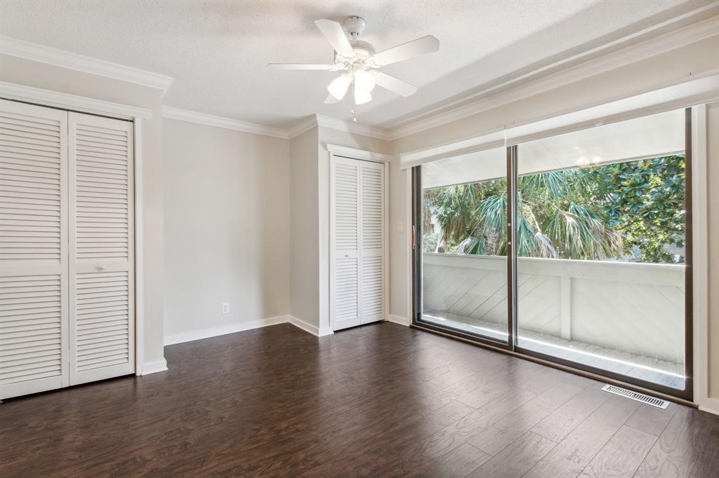 3036 Sea Marsh Road Fernandina Beach, FL 32034 - Photo 26 of 43 an empty room with wooden floor and windows with curtains view
