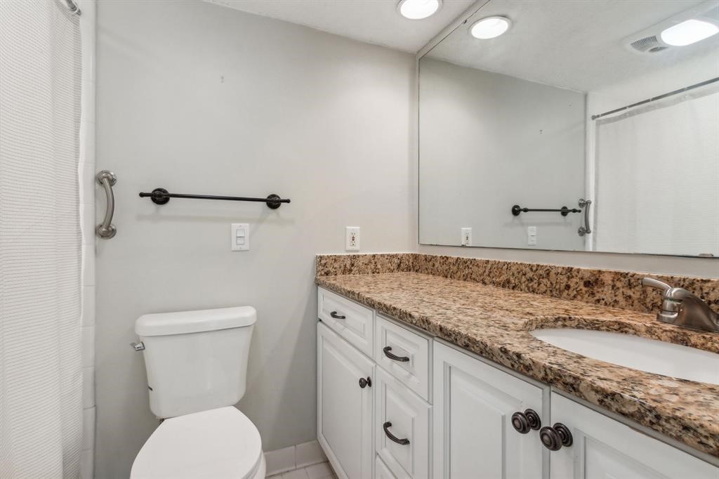 3036 Sea Marsh Road Fernandina Beach, FL 32034 - Photo 28 of 43 a bathroom with a granite countertop toilet sink and mirror