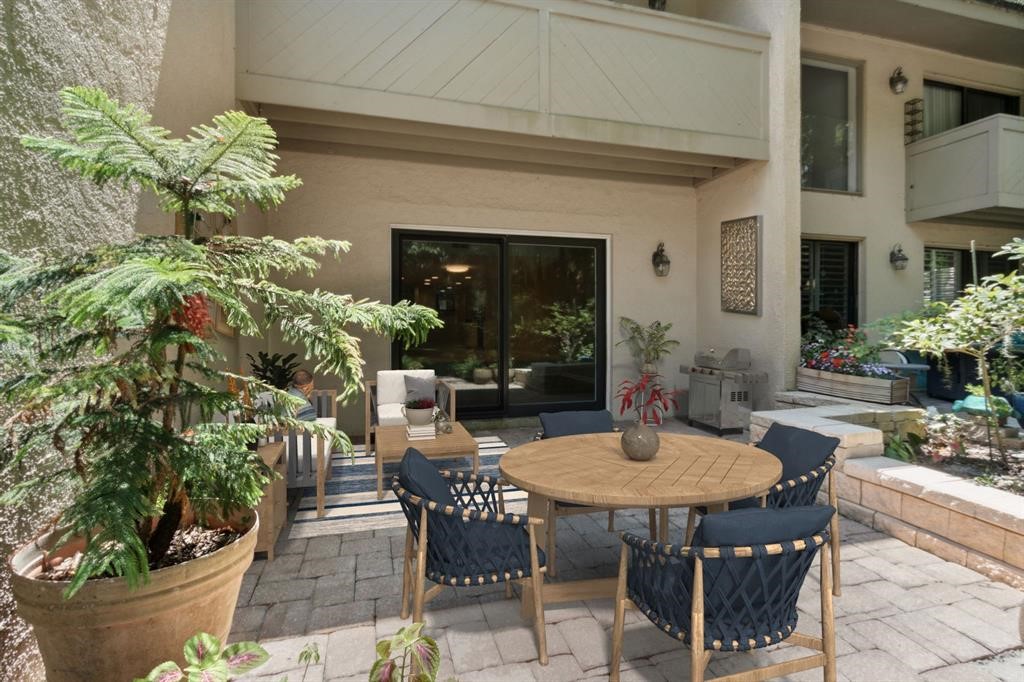 3036 Sea Marsh Road Fernandina Beach, FL 32034 - Photo 30 of 43 a table and chairs in front of a house