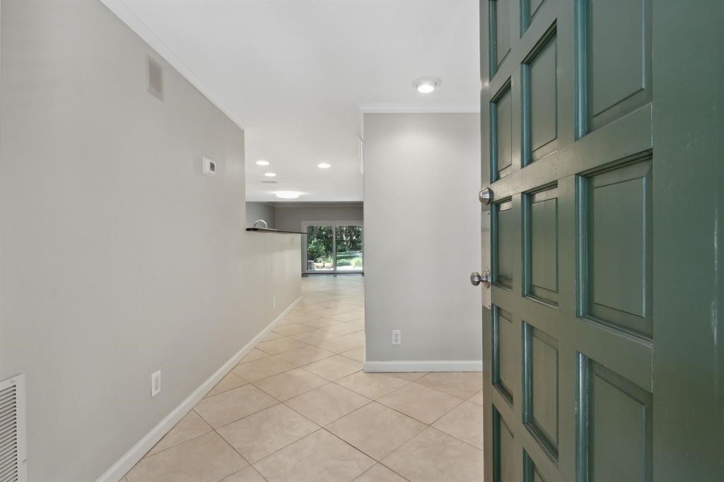 3036 Sea Marsh Road Fernandina Beach, FL 32034 - Photo 5 of 43 a view of hallway with stairs and a refrigerator