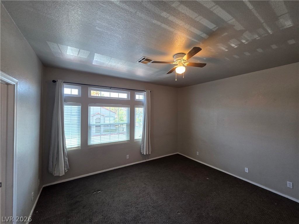 2275 Ramsgate Drive Henderson, NV 89074 - Photo 58 of 84 Well-lit living area features multiple windows and a ceiling fan for comfort.