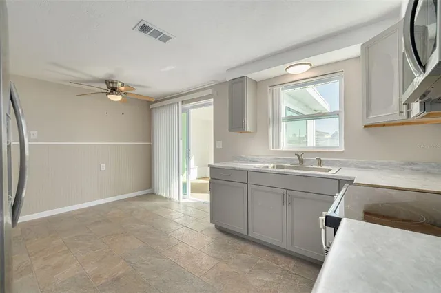 a bathroom with a granite countertop sink mirror and a bathtub