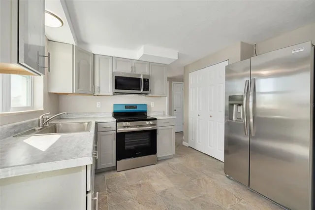 a kitchen with a refrigerator sink and stove