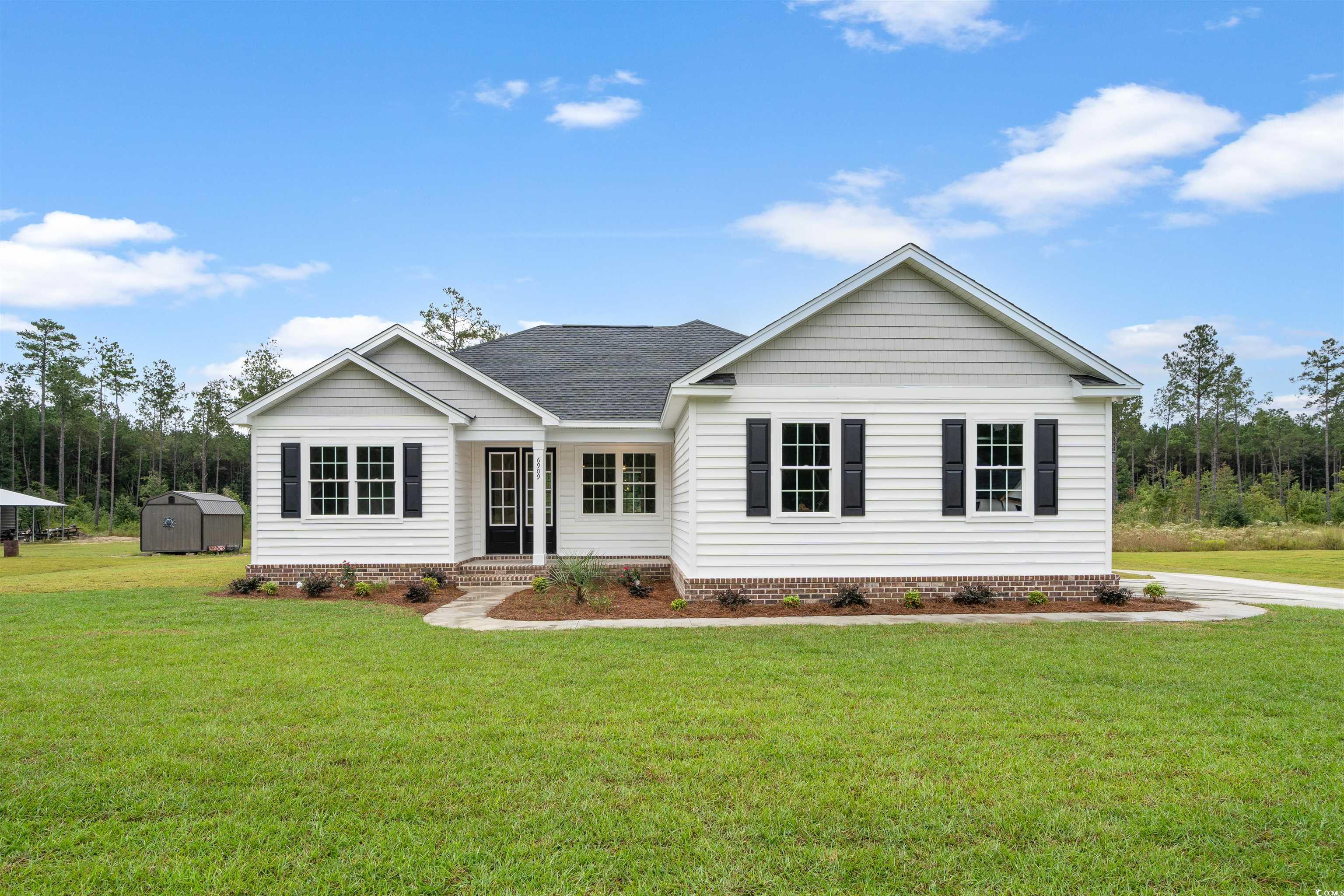 6909 Pauley Swamp Road Conway, SC 29527 - Photo 1 of 40 Single story home featuring a storage unit and a f