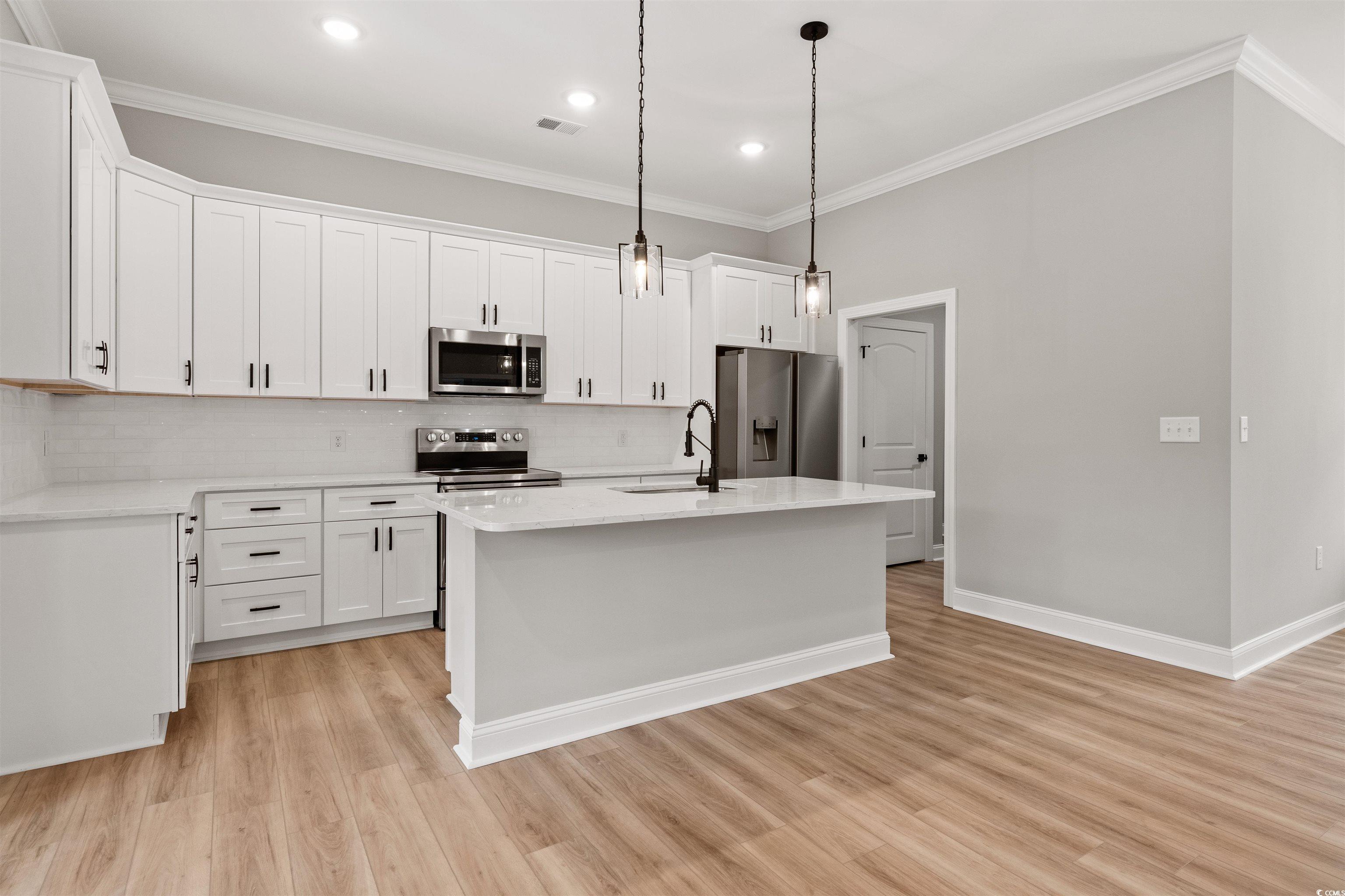 6909 Pauley Swamp Road Conway, SC 29527 - Photo 12 of 40 Kitchen with white cabinetry, stainless steel appl