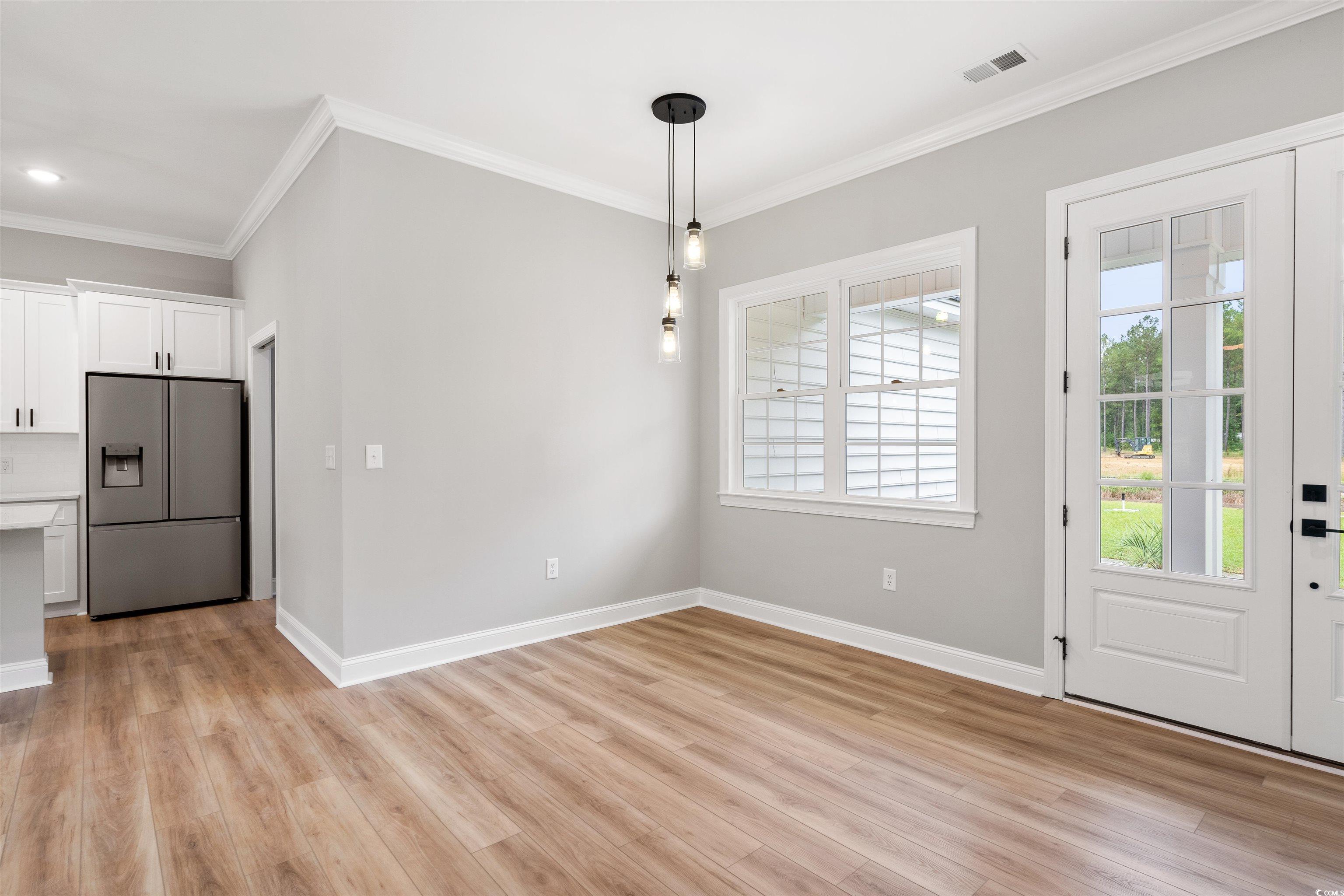 6909 Pauley Swamp Road Conway, SC 29527 - Photo 19 of 40 Unfurnished dining area with ornamental molding an