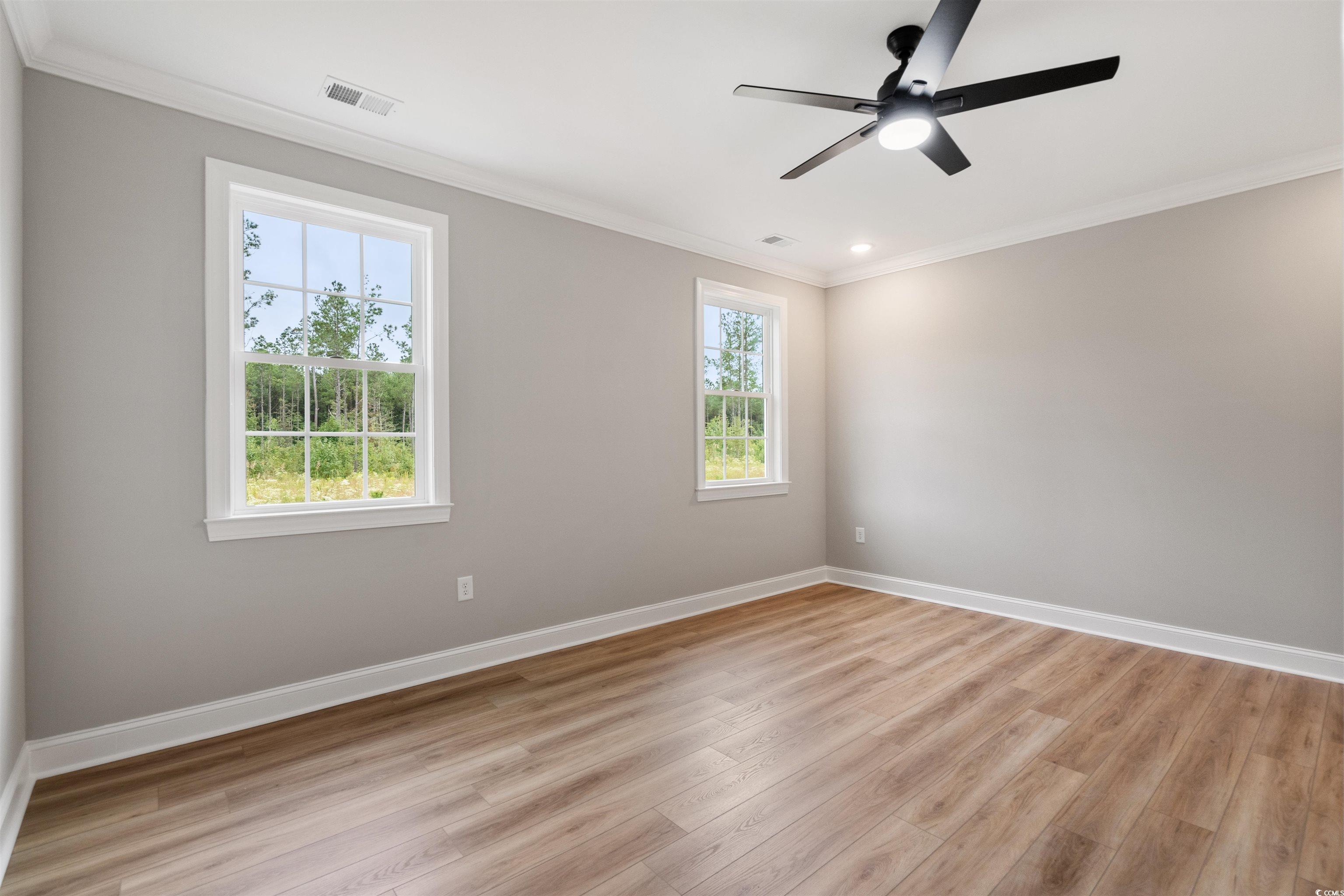 6909 Pauley Swamp Road Conway, SC 29527 - Photo 24 of 40 Empty room with ceiling fan, light wood-type floor